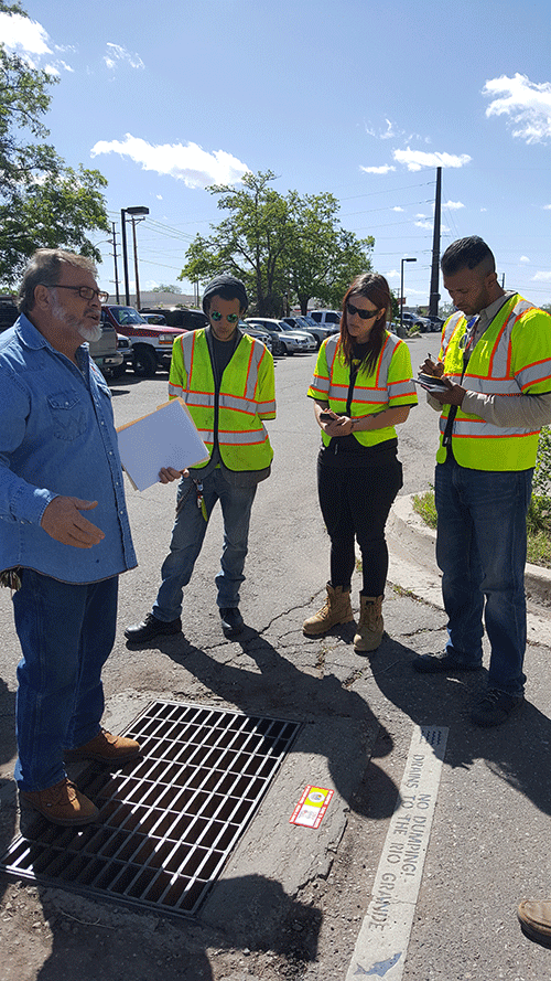 Youthworks! crew applies Only Rain in the Drain markers and collects GPS points